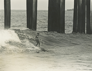 Duline surfing Huntington Beach Pier, 1963. Photo: Jim Driver
